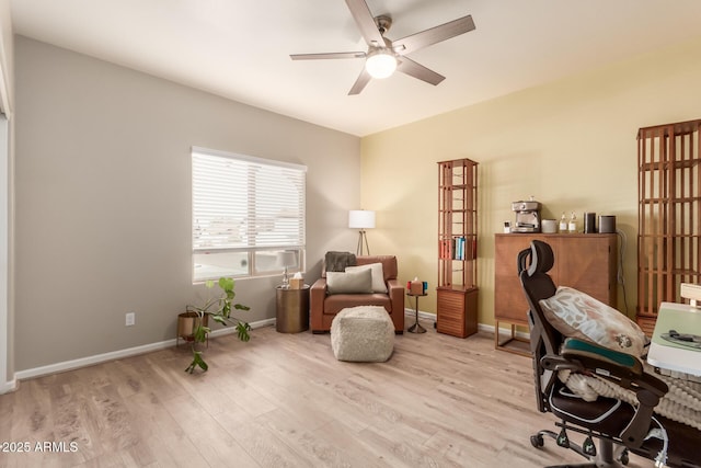 office space with light hardwood / wood-style floors and ceiling fan