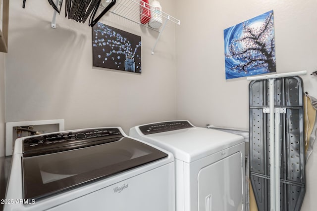 clothes washing area with washing machine and dryer