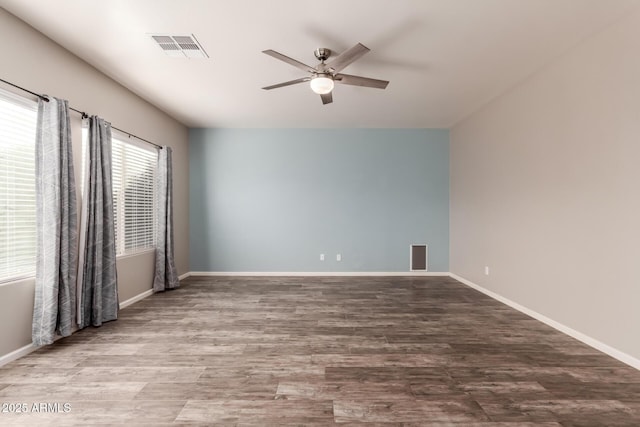 empty room featuring hardwood / wood-style floors and ceiling fan