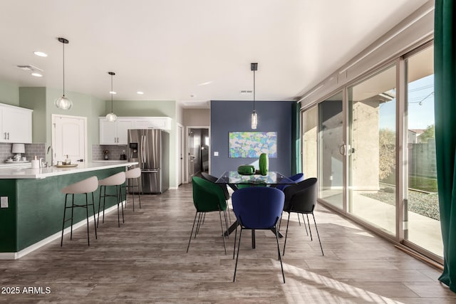 dining space featuring dark hardwood / wood-style flooring and sink