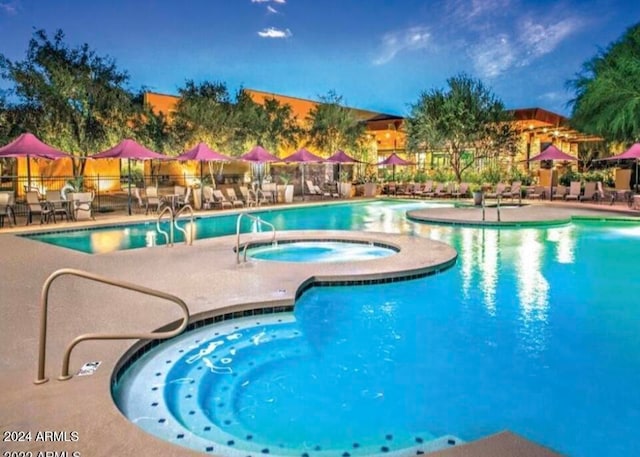 view of swimming pool featuring a hot tub