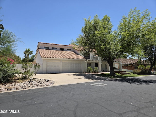 119 E Palomino Dr, Tempe, AZ 85284 - mediterranean / spanish home featuring driveway, a tiled roof, stucco siding, and a garage