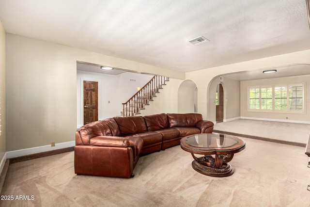 119 E Palomino Dr, Tempe, AZ 85284 - living room featuring carpet flooring, stairs, and arched walkways