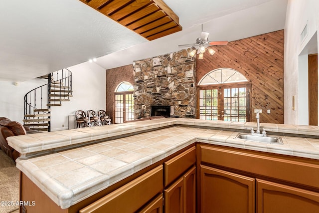 119 E Palomino Dr, Tempe, AZ 85284 - kitchen with open floor plan, ceiling fan, a fireplace, french doors, and wooden walls