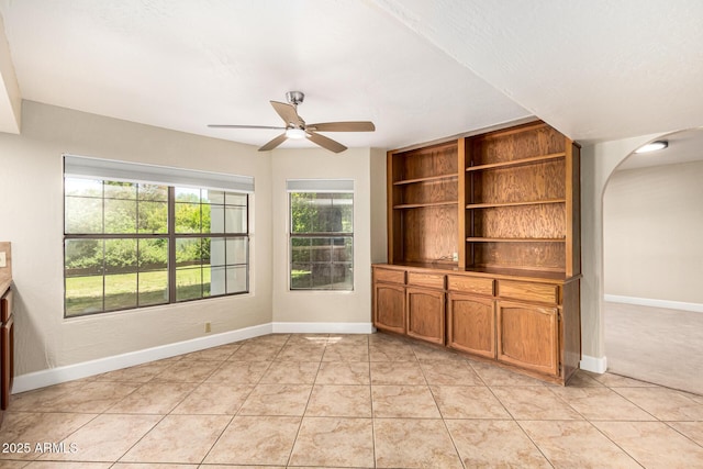 119 E Palomino Dr, Tempe, AZ 85284 - unfurnished living room featuring a ceiling fan, arched walkways, and light tile patterned flooring