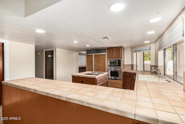 119 E Palomino Dr, Tempe, AZ 85284 - kitchen featuring built in appliances, recessed lighting, a center island, and a peninsula