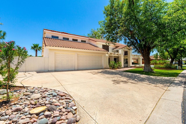 119 E Palomino Dr, Tempe, AZ 85284 - mediterranean / spanish-style house featuring a garage, stucco siding, a tile roof, and driveway