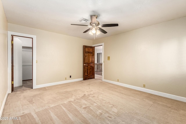 119 E Palomino Dr, Tempe, AZ 85284 - unfurnished bedroom featuring light colored carpet, a ceiling fan, and a walk in closet