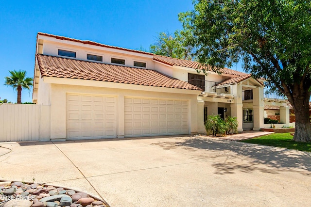 119 E Palomino Dr, Tempe, AZ 85284 - mediterranean / spanish-style house featuring concrete driveway, a balcony, stucco siding, and a tile roof