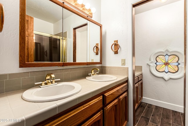 119 E Palomino Dr, Tempe, AZ 85284 - bathroom with double vanity, wood finished floors, and a shower with door