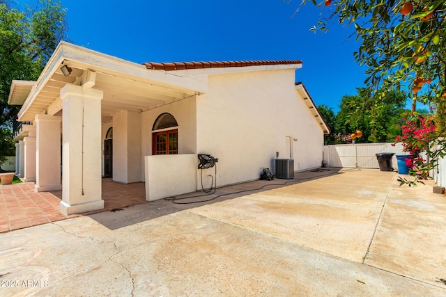 119 E Palomino Dr, Tempe, AZ 85284 - view of home's exterior featuring a tiled roof, stucco siding, a patio area, and a gate