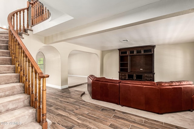 119 E Palomino Dr, Tempe, AZ 85284 - living area featuring wood tiled floors, stairway, and arched walkways