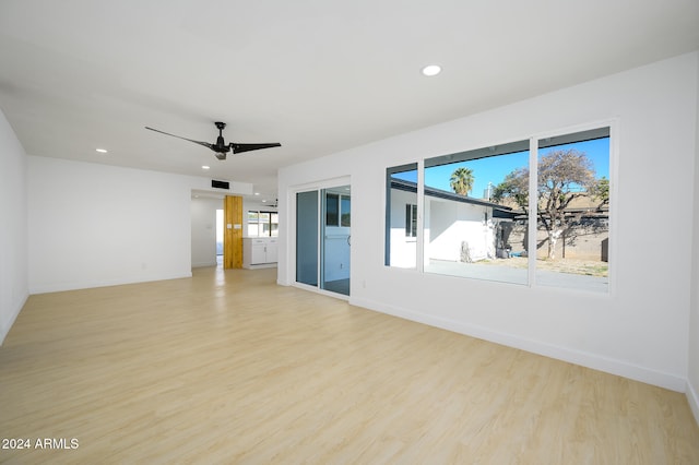 empty room with light hardwood / wood-style flooring and ceiling fan