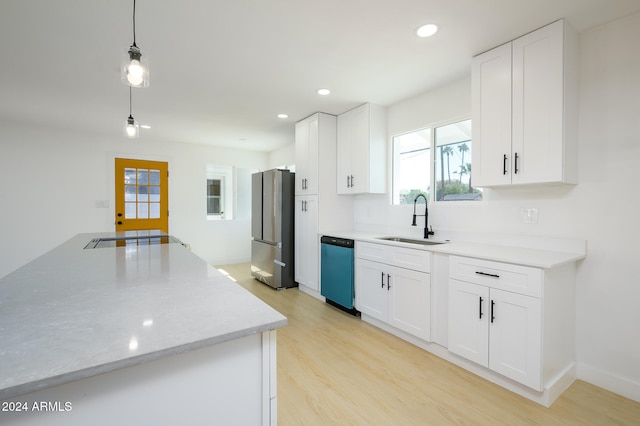 kitchen featuring stainless steel appliances, white cabinetry, decorative light fixtures, sink, and light hardwood / wood-style flooring