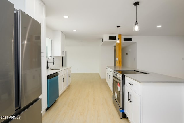 kitchen featuring white cabinets, hanging light fixtures, sink, and appliances with stainless steel finishes