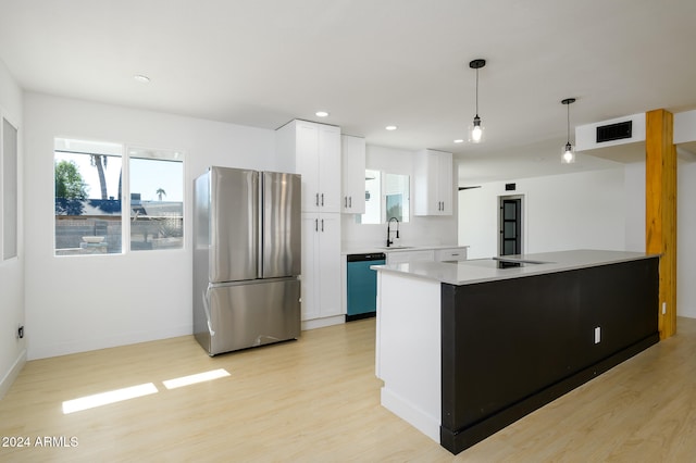 kitchen with white cabinets, appliances with stainless steel finishes, pendant lighting, and a kitchen island