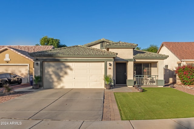 view of front of house featuring a garage and a front lawn