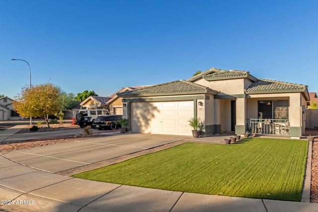 view of front of house featuring a garage and a front lawn