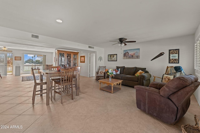 living room with french doors, ceiling fan, and light tile floors