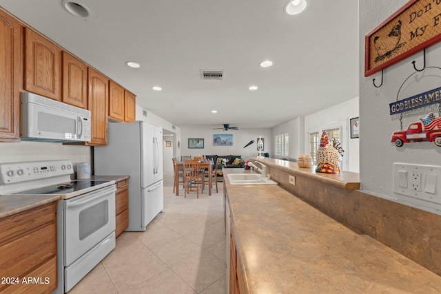 kitchen with light tile floors, ceiling fan, white appliances, and sink