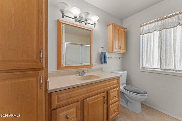 bathroom with tile floors, large vanity, and toilet