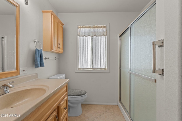 bathroom featuring walk in shower, tile flooring, toilet, and vanity