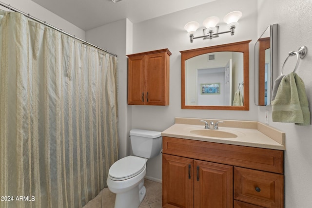 bathroom featuring tile floors, toilet, and oversized vanity