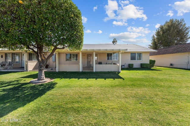 ranch-style home featuring a front yard