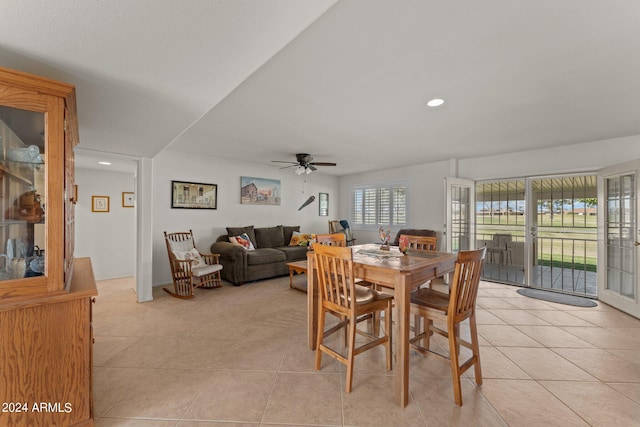 tiled dining space featuring ceiling fan