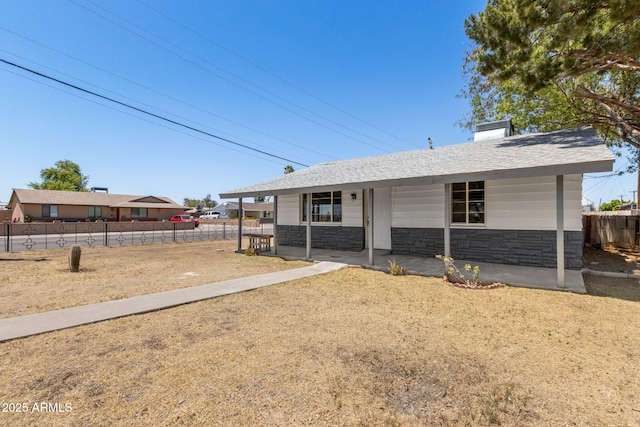 4048 W Granada Rd, Phoenix, AZ 85035 - single story home featuring stone siding, a shingled roof, a chimney, and a porch