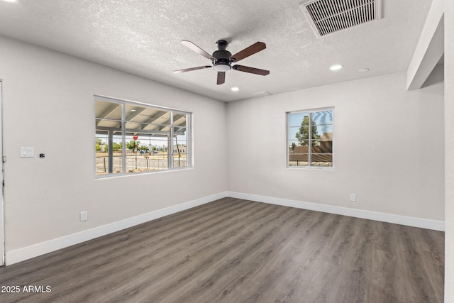 4048 W Granada Rd, Phoenix, AZ 85035 - empty room featuring a ceiling fan, dark wood-style floors, a textured ceiling, and recessed lighting