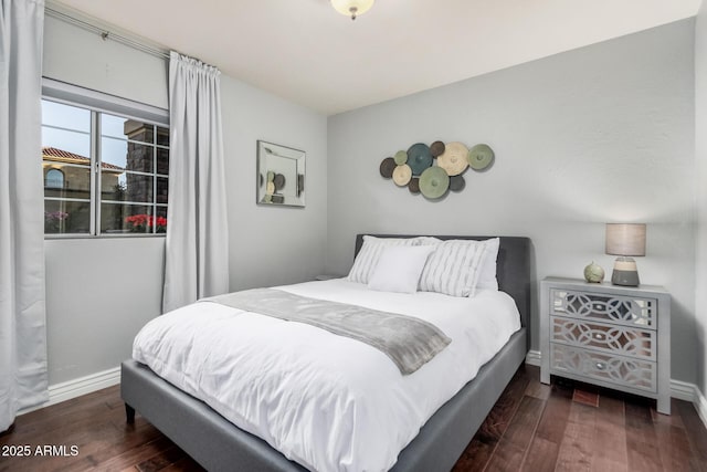 bedroom with dark wood-type flooring