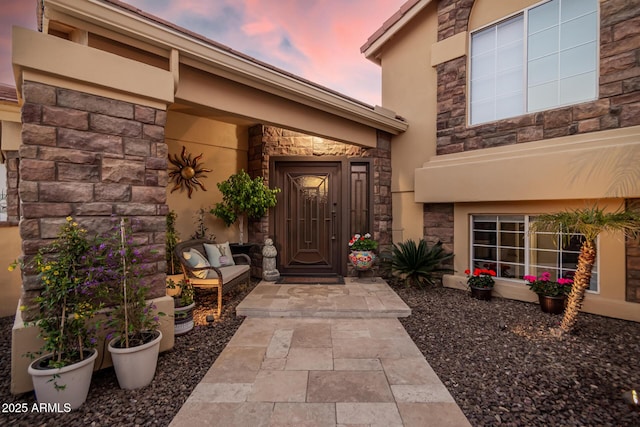 view of exterior entry at dusk