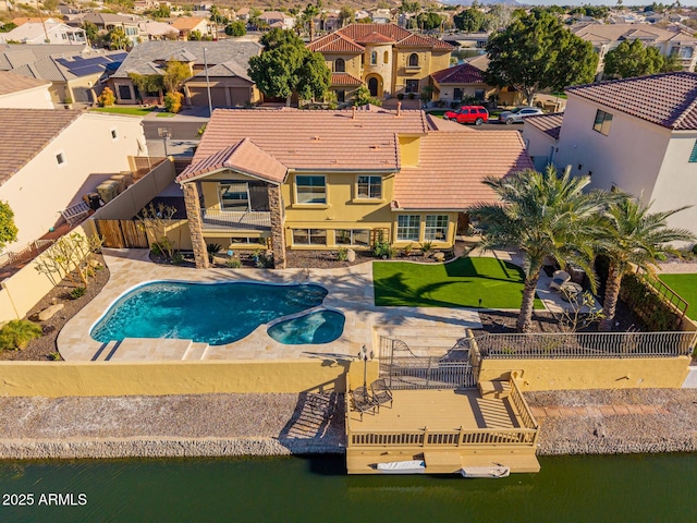 view of swimming pool featuring a patio and a water view