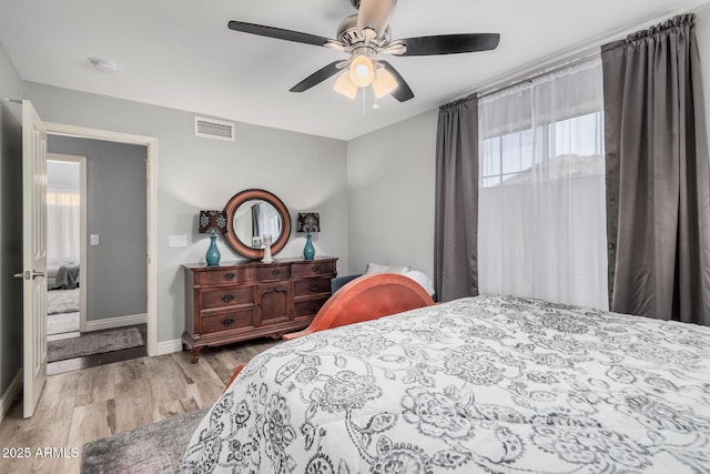 bedroom featuring light hardwood / wood-style floors and ceiling fan