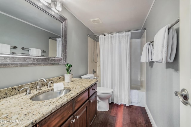 full bathroom with wood-type flooring, ornamental molding, vanity, shower / tub combo, and toilet