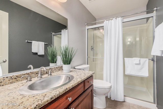 bathroom with vanity, curtained shower, tile patterned floors, and toilet