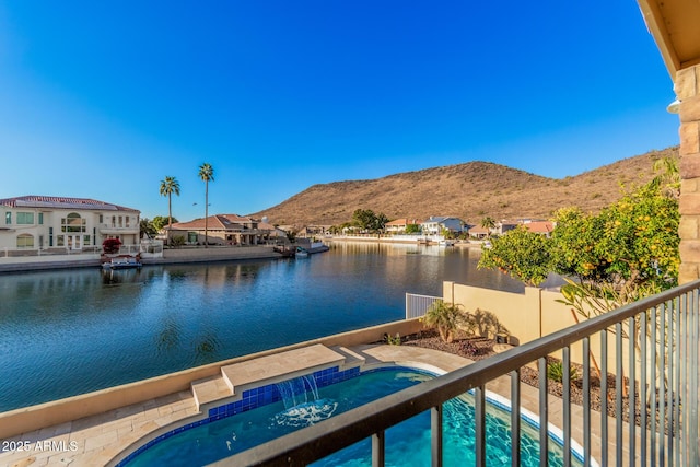 view of dock featuring a water and mountain view and pool water feature