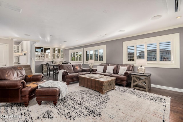 living room featuring crown molding and light hardwood / wood-style flooring