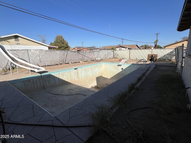 view of swimming pool with a water slide and a diving board