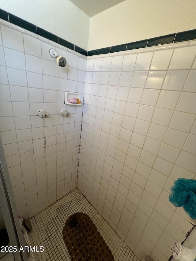 bathroom with a tile shower