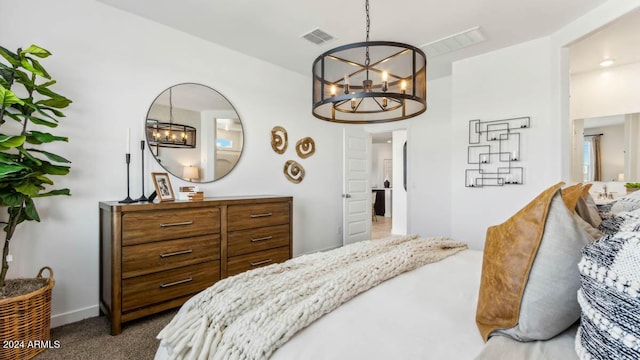 carpeted bedroom with visible vents, baseboards, and a notable chandelier