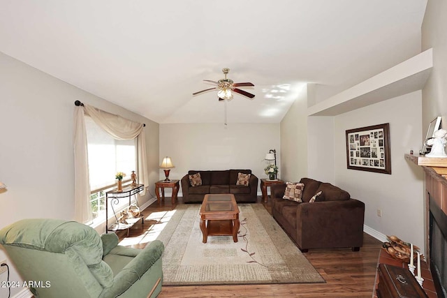 living room with dark hardwood / wood-style floors and ceiling fan