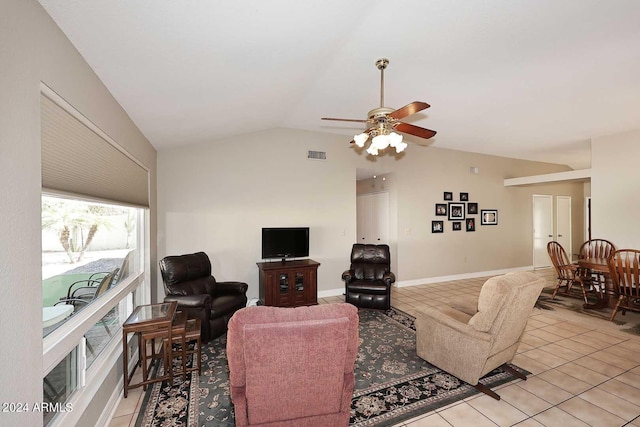 tiled living room featuring ceiling fan and lofted ceiling