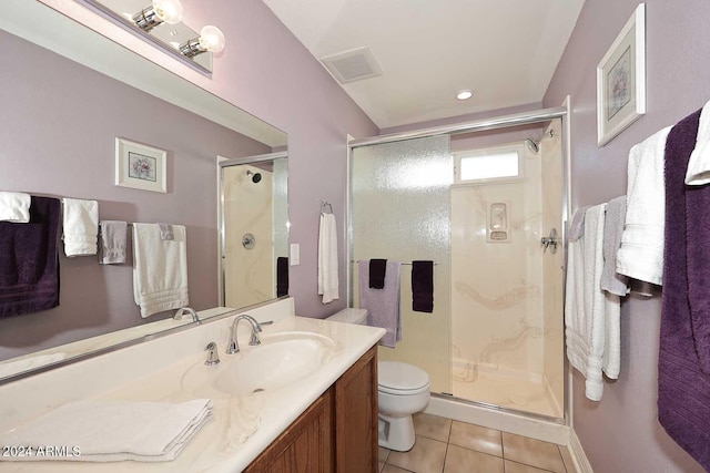 bathroom with vanity, a shower with shower door, tile patterned floors, and toilet