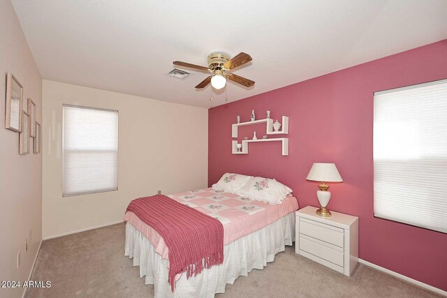 bedroom featuring ceiling fan and light carpet