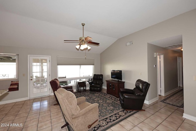 living room with ceiling fan, light tile patterned floors, and lofted ceiling