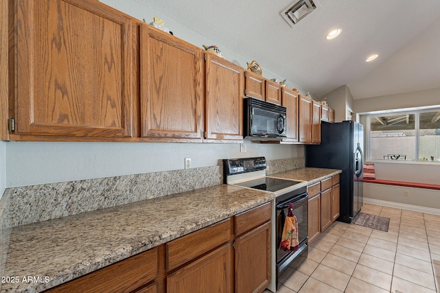 kitchen with black appliances, light stone countertops, lofted ceiling, and light tile patterned flooring