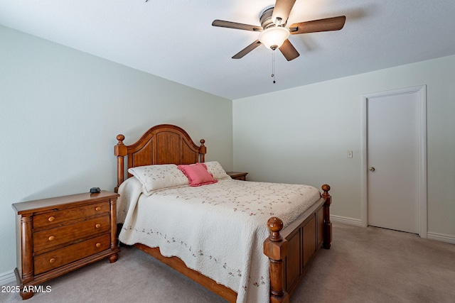 bedroom with ceiling fan and light carpet