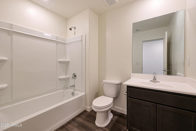 bathroom with shower / bathtub combination, visible vents, toilet, vanity, and wood finished floors